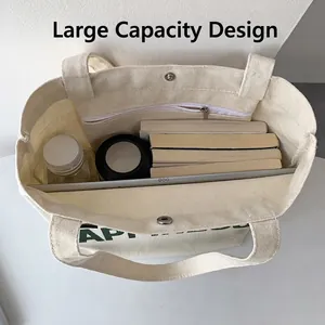 Grand sac fourre-tout en toile blanc cassé avec compartiments internes et livres