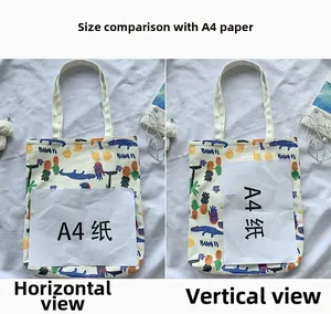 Canvas tote bag size comparison with A4 paper showing colorful dinosaur prints