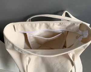 Detail view of large canvas tote bag interior with zipper pocket and neat stitching