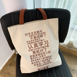Detailed close-up of durable canvas tote bag with brown straps and inspirational text