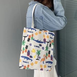 Detailed shot of a canvas tote bag with colorful Hawaii tropical print and white handle