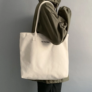 Detail of off-white canvas tote bag with by morisot print and wide shoulder straps