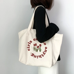 Minimalist off-white canvas tote bag with red tulip print and long shoulder straps