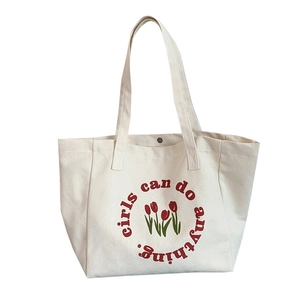 Minimalist tulip canvas tote bag with Girls can do anything print and red flower design