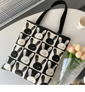 Detail of cute rabbit print canvas tote bag with black and white checkerboard pattern