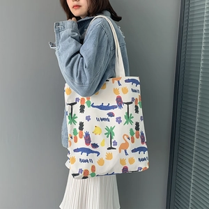 Detail of Hawaii style canvas tote bag featuring colorful tropical animal and fruit prints