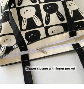 Detail view of canvas tote bag featuring secure top zipper closure and inner pocket