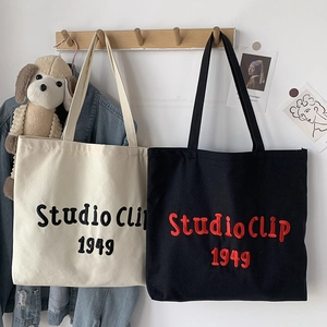 Minimalist canvas tote bags with Studio Clip 1949 embroidery in black and white colors