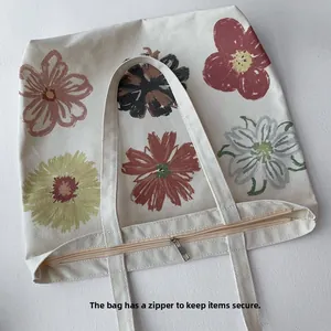 Detailed view of canvas tote bag with floral print and secure zipper closure