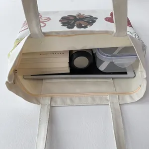 Top view of cream canvas tote bag interior showing large capacity for books and tablet