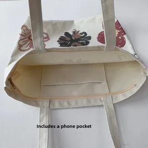 Interior view of floral canvas tote bag featuring an inner pocket and zipper closure