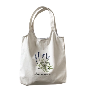 White canvas tote bag featuring purple lavender plant illustration and printed text
