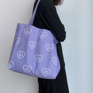 Détail du sac cabas violet avec motifs cœurs blancs et texte en français Tu es aimé