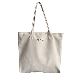 Minimalist off-white canvas tote bag with black by morisot text for daily travel