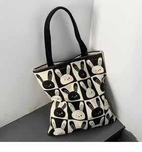 Detail of canvas tote bag with black and white checkerboard and cute rabbit print