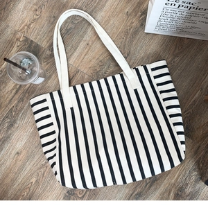 Large capacity striped canvas tote bag with black and white vertical patterns for daily use