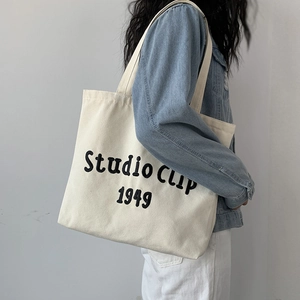 Detail of Studio Clip 1949 lettering on a minimalist cream canvas tote bag