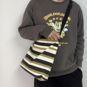 Minimalist striped canvas crossbody bag for women featuring green and black wide stripes