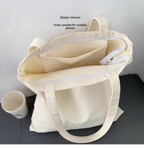 Détail de la fermeture éclair et de la poche intérieure pour téléphone du sac en toile