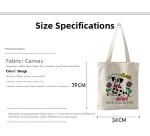 Détail du sac fourre-tout en toile beige montrant la fermeture éclair et la poche interne