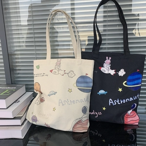 Minimalist canvas tote bags in black and beige with astronaut and rabbit cartoon prints