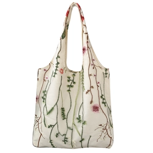 Cream embroidered floral canvas tote bag with elegant botanical patterns on white background