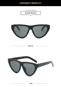 Front and side view of trendy black oversized triangle cat-eye sunglasses with dark lenses