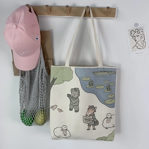Detail of canvas tote bag featuring forest adventure cartoon animals with a bear and fox