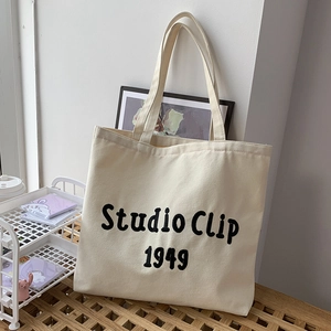 Detail of Studio Clip 1949 canvas tote bag showing thick fabric and black lettering