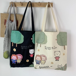 Detail view of durable canvas tote bags featuring forest animal illustrations and quotes