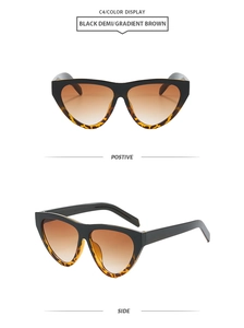 Detail view of large triangle sunglasses with black and demi frames and brown gradient lenses