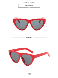 Detail view of bold red cat-eye sunglasses with dark black lenses, color code C6