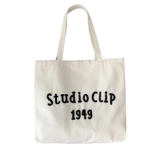 Minimalist off-white canvas tote bag with Studio Clip 1949 embroidery and dual shoulder straps