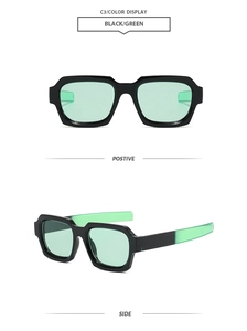 Detail view of vintage square sunglasses with black frames and translucent green lenses