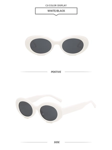 Detail view of oval white sunglasses with thick frames and dark lenses in two angles