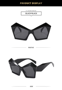 Détails montrant la monture géométrique noire et les charnières métalliques des lunettes