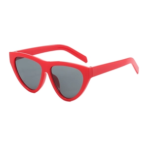 Retro red cat eye sunglasses with dark grey lenses in a 45-degree angle studio shot