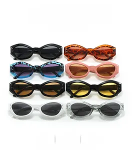 Flat lay of retro cat-eye sunglasses in various colors with metallic rivet details