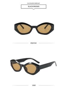 Close-up of black cat-eye sunglasses with brown lenses and silver rivet details