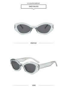 Front and 45-degree angle view of transparent grey cat-eye sunglasses with dark lenses