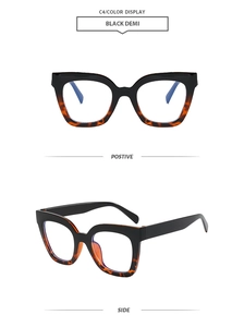 Detail view of square color-blocked glasses frames in black and tortoiseshell finish