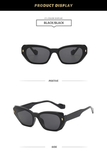 Detail view of stylish square sunglasses with golden geometric studs on black frames