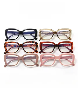 Flat lay of retro chunky eyeglass frames in black, tortoiseshell, and pastel colors