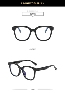 Detail view of glossy black square eyeglass frames with metallic temple accents