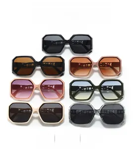 Flat lay view of hexagonal oversized sunglasses in seven colors with letter B temple detail