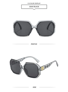 Detail of gray hexagonal sunglasses with hollow temples and golden metal letter B logo