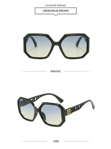 Detail of green polygon sunglasses with blue-brown gradient lenses and golden B logo
