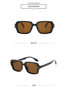 Détail de lunettes de soleil carrées avec accents dorés et branches à texture gaufrée