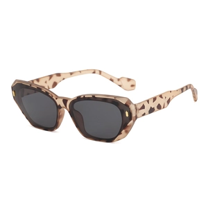 Fashionable tortoise shell cat-eye sunglasses with dark grey lenses and gold accents