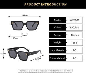 Detail view of black rectangular sunglasses with golden metal G-logo on temple hinge